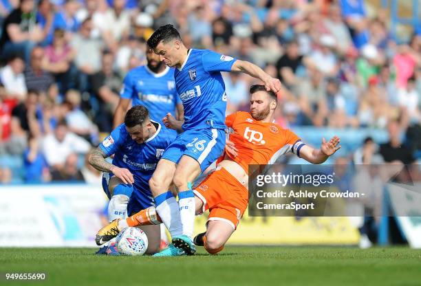 Gillingham's Callum Reilly is tackled by Blackpool's Jimmy Ryan during the Sky Bet League One match between Gillingham and Blackpool at Priestfield...