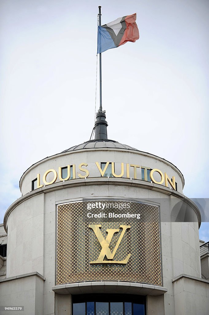 A flag flies on top of a Louis Vuitton store in Paris, France, on