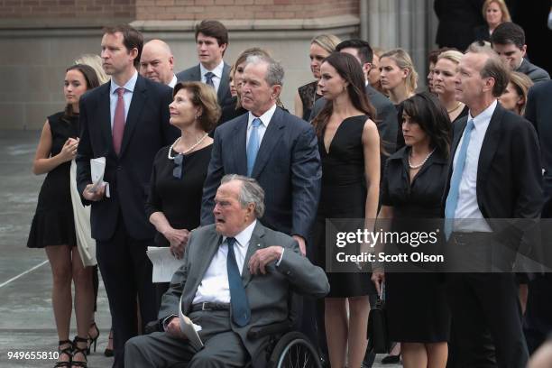 Former president George H.W. Bush and son, former president George W. Bush, watch with family as the coffin of former first lady Barbara Bush is...