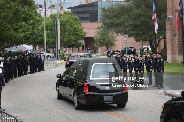 Police salute as the remains of former first lady Barbara Bush leave St. Martin's Episcopal Church following her funeral service on April 21, 2018 in...