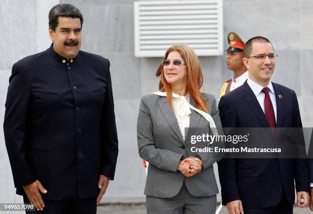 Venezuelan President Nicolas Maduro stands next to his wife Cilia Flores as they take part in a floral offering for the monument to Cuban National...