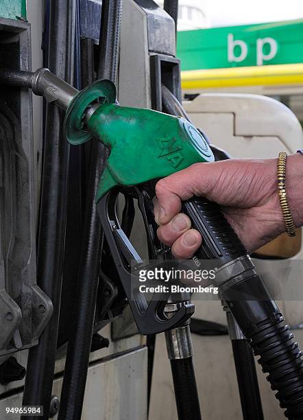 Customer selects a nozzle at a BP gas station in London, U.K., on Tuesday, July 28, 2009. BP Plc, Europe?s second-biggest oil company, said profit...