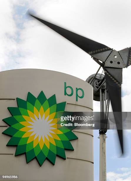 Sign sits in front of a wind turbine at a gas station in London, U.K., on Tuesday, July 28, 2009. BP Plc, Europe?s second-biggest oil company, said...