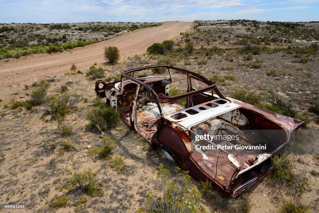 Rusty car wreck at the roadside, Camarones, Chubut, Argentina
