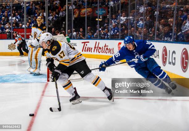 Torey Krug of the Boston Bruins skates against Mitchell Marner of the Toronto Maple Leafs in Game Four of the Eastern Conference First Round during...