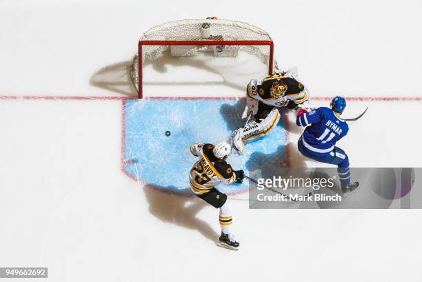 Zach Hyman of the Toronto Maple Leafs goes to the net against Tuukka Rask and Charlie McAvoy of the Boston Bruins in Game Four of the Eastern...