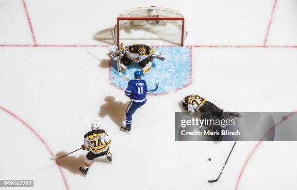 Zach Hyman of the Toronto Maple Leafs goes to the net against Tuukka Rask, Jake DeBrusk, and Charlie McAvoy of the Boston Bruins in Game Four of the...
