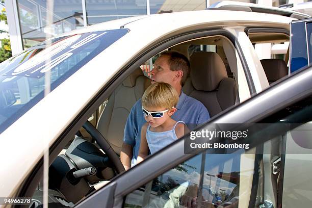 Patrick Wentland and his daughter Cassidy looks inside a Saturn Outlook at the Saturn of Chapel Hills dealership in Colorado Springs, Colorado, U.S.,...