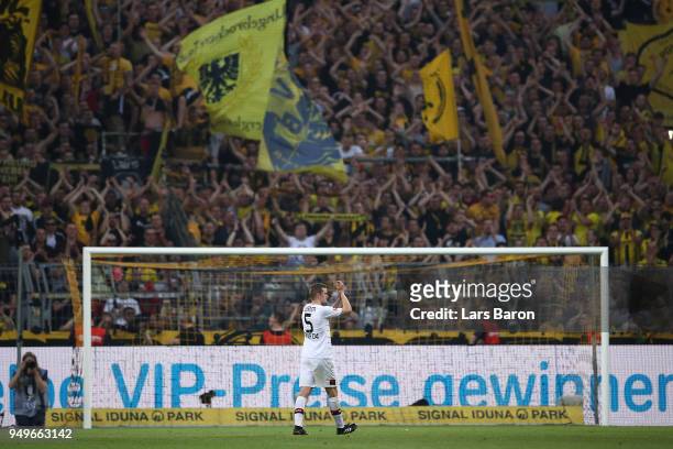Sven Bender of Bayer Leverkusen applauds the Dortmund supporters as they cheer him, after the Bundesliga match between Borussia Dortmund and Bayer 04...