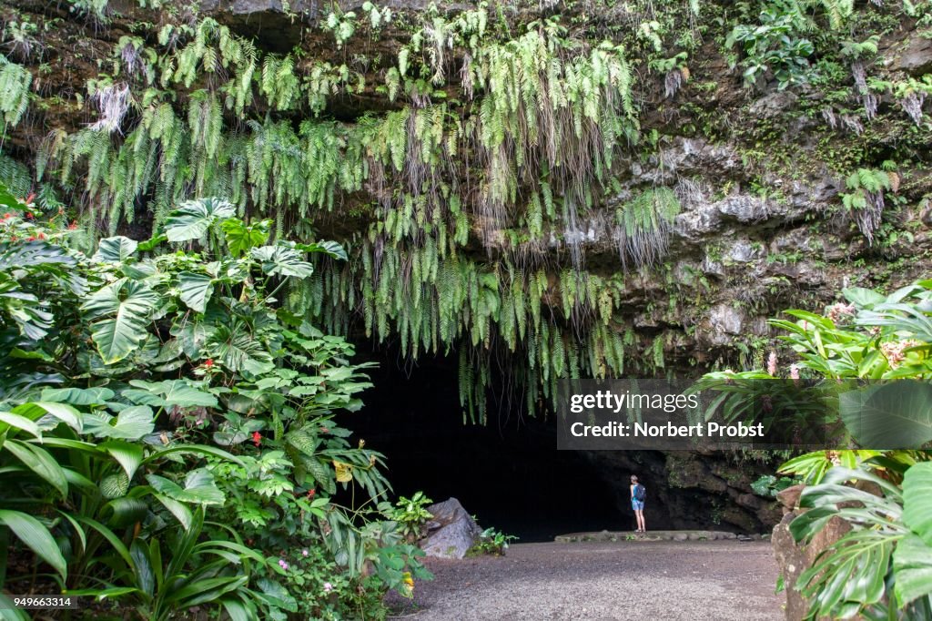 Woman standing in front of Maraa Grotto, Grotto, Cave, Fern, Taravao, Tahiti, French Polynesia