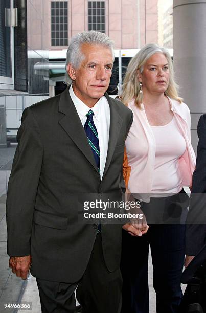 James M. Davis, former chief financial officer of Stanford Financial Group Co., and wife Lori arrive for a hearing at the Bob Casey Federal...