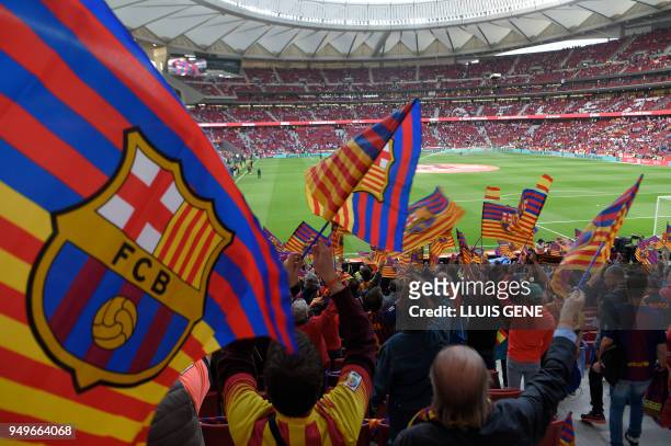 Barcelona's supporters wave flags before the Spanish Copa del Rey final football match Sevilla FC against FC Barcelona at the Wanda Metropolitano...