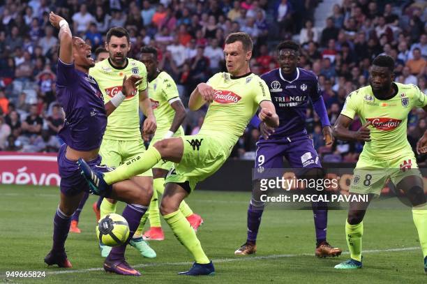 Toulouse's French defender Christopher Jullien vies with Angers' French defender Romain Thomas during the French L1 football match Toulouse against...