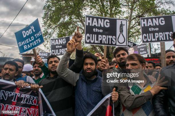 Kashmir Muslims hold placards during a protest in Srinagar, the summer capital of Indian administered Kashmir. Protesters staged protest today at...