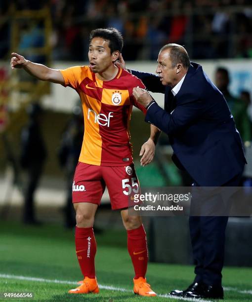 Head coach of Galatasaray Fatih Terim gives tactics to his player Yuto Nagatoma during Turkish Super Lig soccer match between Aytemiz Alanyaspor and...