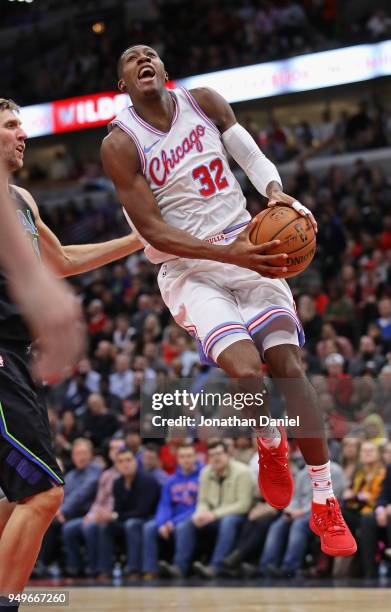 Kris Dunn of the Chicago Bulls drives past Dirk Nowitzki of the Dallas Mavericks at the United Center on March 2, 2018 in Chicago, Illinois. The...