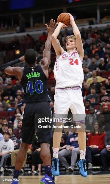 Lauri Markkanen of the Chicago Bulls shoots over Harrison Barnes of the Dallas Mavericks at the United Center on March 2, 2018 in Chicago, Illinois....