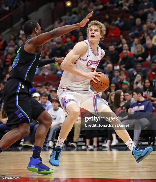 Lauri Markkanen of the Chicago Bulls moves against Harrison Barnes of the Dallas Mavericks at the United Center on March 2, 2018 in Chicago,...