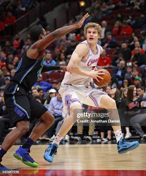 Lauri Markkanen of the Chicago Bulls moves against Harrison Barnes of the Dallas Mavericks at the United Center on March 2, 2018 in Chicago,...