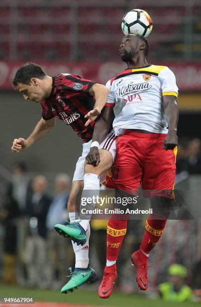 Giacomo Bonaventura of AC Milan jumps for the ball against Bacary Sagna of Benevento Calcio during the serie A match between AC Milan and Benevento...
