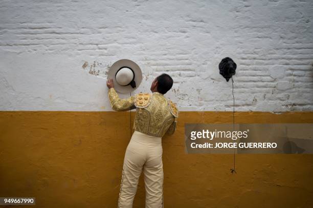 Picador hangs his hat before a bullfight at the Maestranza bullring in Sevilla on April 21, 2018.