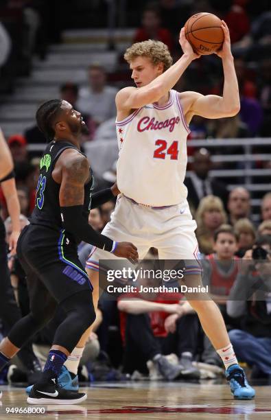 Lauri Markkanen of the Chicago Bulls looks to move against Wesley Matthews of the Dallas Mavericks at the United Center on March 2, 2018 in Chicago,...