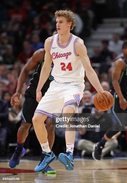 Lauri Markkanen of the Chicago Bulls moves around Harrison Barnes of the Dallas Mavericks at the United Center on March 2, 2018 in Chicago, Illinois....