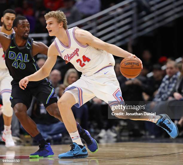 Lauri Markkanen of the Chicago Bulls moves around Harrison Barnes of the Dallas Mavericks at the United Center on March 2, 2018 in Chicago, Illinois....