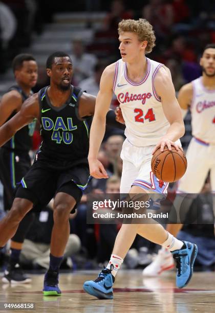 Lauri Markkanen of the Chicago Bulls moves around Harrison Barnes of the Dallas Mavericks at the United Center on March 2, 2018 in Chicago, Illinois....