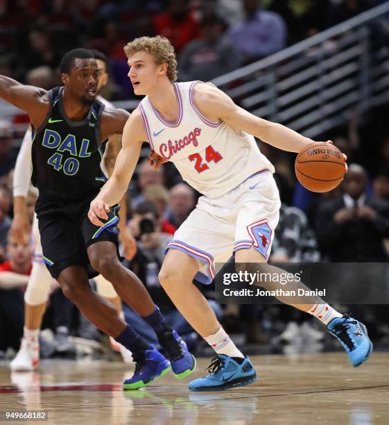 Lauri Markkanen of the Chicago Bulls moves around Harrison Barnes of the Dallas Mavericks at the United Center on March 2, 2018 in Chicago, Illinois....