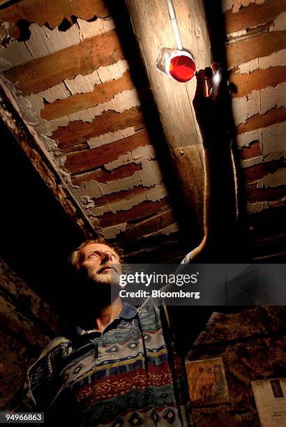 Eric Perret examines a glass of wine at Chateau Bousquette in Cessenon, France, on Thursday, Aug. 20, 2009. Heightened consumer demand for wholesome...