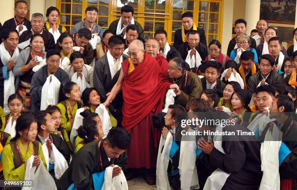 Tibetan spiritual leader the Dalai Lama poses for a group photo with Tibetans at the Tsuglakhang temple on April 21, 2018 in Dharamsala, India.