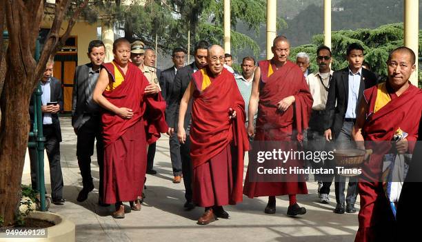 Tibetan spiritual leader the Dalai Lama is greeted by devotees as he arrives to give a talk at the Tsuglakhang temple on April 21, 2018 in...