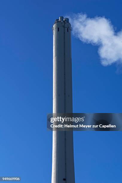 smoking chimney from a heating power plant, blue sky, erlangen, middle franconia, bavaria, germany - erlangen stock pictures, royalty-free photos & images