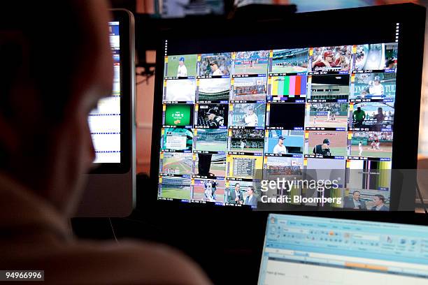 Major League Baseball Advanced Media employee monitors games that are being streamed live to pay subscribers at the BAM operations center in New...