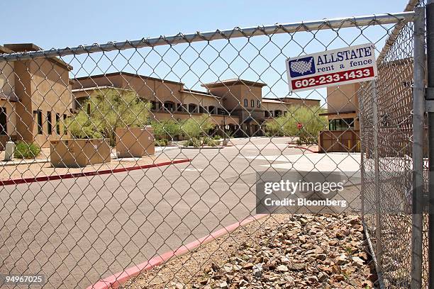 Fence surrounds Peaks Corporate Park, a five building 000-square-foot office development that is unoccupied in Scottsdale, Arizona, U.S., on Tuesday,...