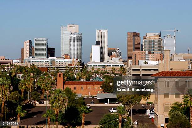 Buildings, including a tower under construction at right, dot the skyline of Phoenix, Arizona, U.S., on Tuesday, Aug. 18, 2009. The housing slump has...