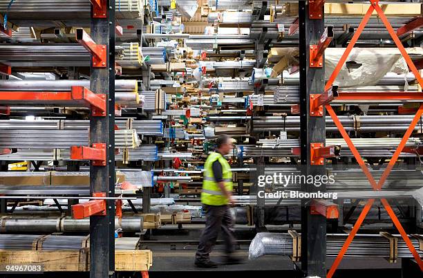 An employee walks through the warehouse at Righton metal distributors in Birmingham, U.K., on Wednesday, Aug. 19, 2009. Copper rose from a two-week...