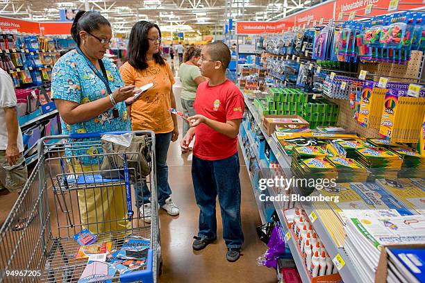Darlene Soto, left, shops for school supplies with her children Samantha who is starting 12th grade, center, and James who is starting 6th grade, at...
