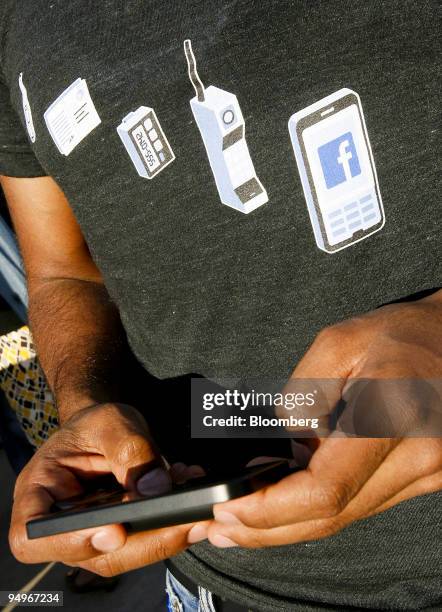 Ankur Pansari, a sales engineer for Facebook Inc., uses the company's mobile application on a T-Mobile G1 smartphone powered by the Google Android...