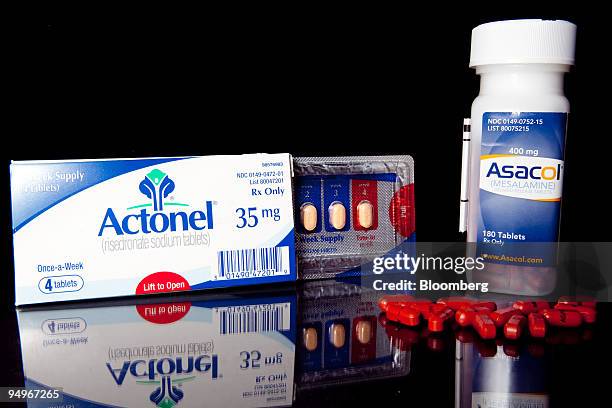 Procter & Gamble Co.'s osteoporosis treatment Actonel and bowel disorder medicine Asacol are arranged for a photograph at C.O. Bigelow Pharmacy in...