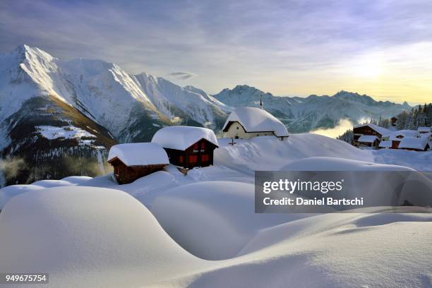 deep snow-covered mountain village, bettmeralp with chapel maria zum schnee in the evening light, canton valais, switzerland - alpen schnee fotografías e imágenes de stock