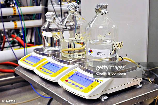 Jugs of ammonium hydroxide are weighed and monitored in a fermentation lab at the Cubist Pharmaceuticals production facility in Lexington,...