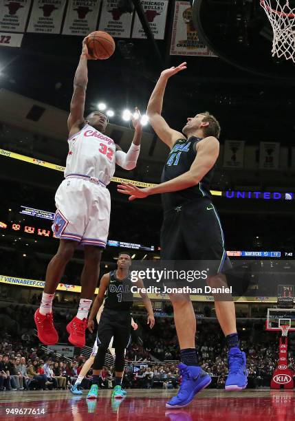 Kris Dunn of the Chicago Bulls shoots against Dirk Nowitzki of the Dallas Mavericks at the United Center on March 2, 2018 in Chicago, Illinois. The...