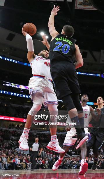 Denzel Valentine of the Chicago Bulls shoots under pressure from Doug McDermott of the Dallas Mavericks at the United Center on March 2, 2018 in...