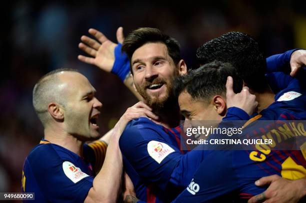 Barcelona's Uruguayan forward Luis Suarez celebrates with Barcelona's Spanish midfielder Andres Iniesta, Barcelona's Argentinian forward Lionel Messi...