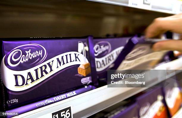 Customer selects a bar of Cadbury's Dairy Milk chocolate in a store in Hornchurch, U.K., on Monday, Sept. 7, 2009. Kraft Foods Inc., the...