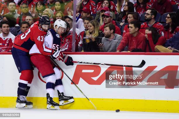 Tom Wilson of the Washington Capitals and Markus Nutivaara of the Columbus Blue Jackets battle for the puck in the first period in Game Five of the...