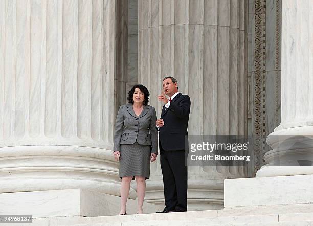 Supreme Court Justice Sonia Sotomayor, left, speaks with Chief Justice John Roberts, after taking a ceremonial oath of office in Washington, D.C.,...