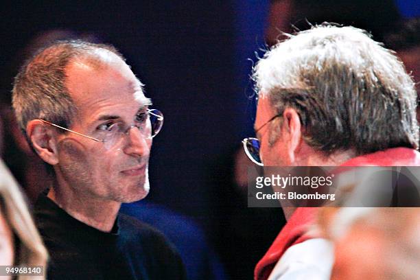 Steve Jobs, chief executive officer of Apple Inc., left, speaks with Eric Schmidt, chief executive officer of Google Inc., during an Apple product...